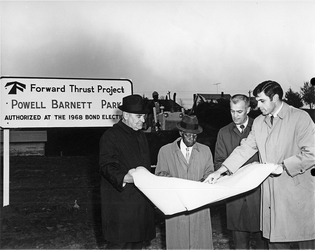 Powell Barnett being shown development plans by John O. Andrew, former Chair of the Board of Parks Commissioners (left), Hans A. Thompson, superintendent, Roy Lehner, designer, David Jensen Association. Photo courtesy of the Seattle Municipal Archives