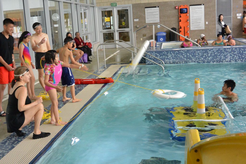 Kids learn how to safely aid other swimmers.