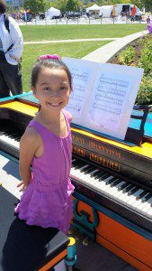 Girl playing piano in park