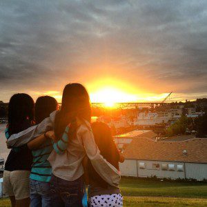 Four girls watch sunset at Gas Works Park