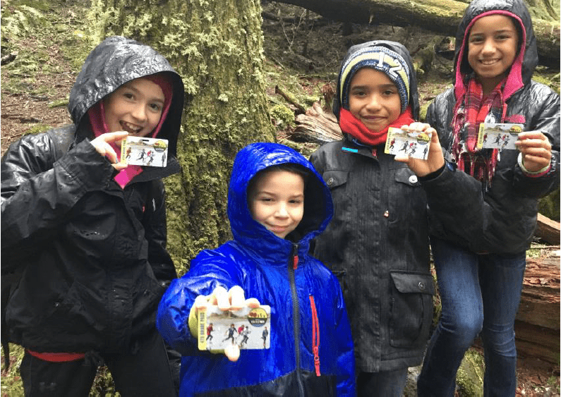 Fourth graders on a field trip to Mount Rainier National Park show off their Every Kid in a Park passes