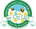 A logo of the Bee City USA organization. It reads "Making the World Safer for Pollinators One City at a Time". 