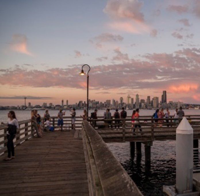 A picture shows a West Seattle pier overlooking Elliot Bay at dusk.