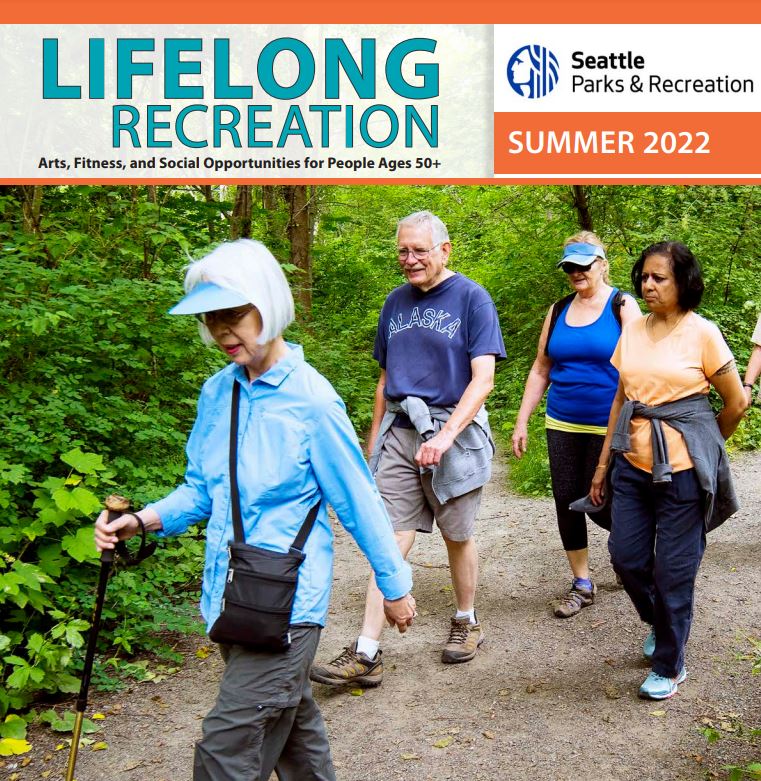 The cover of the Seattle Parks and Recreation Lifelong Recreation summer 2022 brochure is shown. Four people are hiking along a trail in the forest. 
