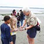 Kids and nature docent on beach in Discovery Park