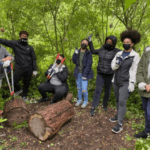 Group of people in masks in a forest volunteering
